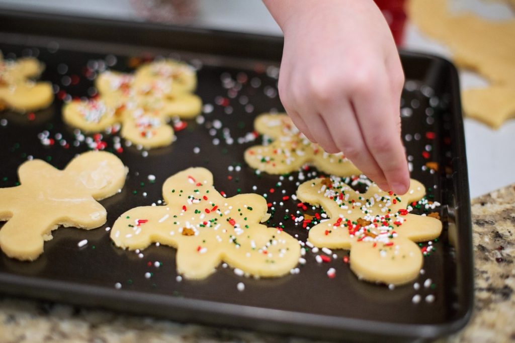Easy involvement of kids in baking for decorating can help boost their imagination Tiny hands working on cookies